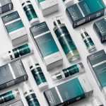 Male grooming skincare products from Bielenda Supremelab, pictured against a white background in a criss-cross pattern to show off their distinctive dark blue and green packaging.