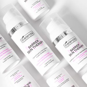 Product shot of Barrier Skin Therapy creams from BIELENDA PROFESSIONAL. Picture shows a series of opaque white bottles with pink and black text, lying next to each other against a white background. They are aligned in a pattern resembling bricks in a wall.